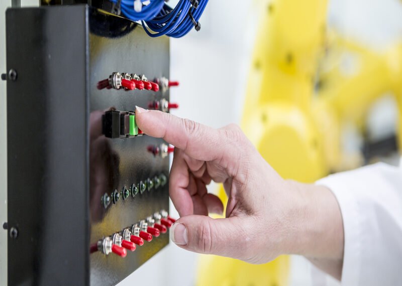 close-up-of-woman-switching-on-switch-in-factory-2024-09-19-03-26-49-utc (1)